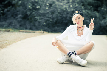 Fototapeta na wymiar Swag attractive female girl posing with lollipop in nature.
