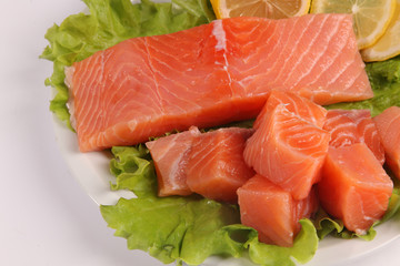 salmon on a plate with salad and lemon
