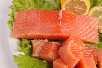 salmon on a plate with salad and lemon