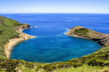 Fototapeta na wymiar Bay in Azores in Atlantic ocean on a background of of blue sky and juicy greenery