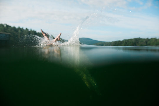Boy diving into lake