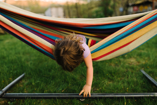 Young girl in hammock, leaning out