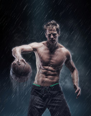 Portrait of shirtless wet bascetball player.