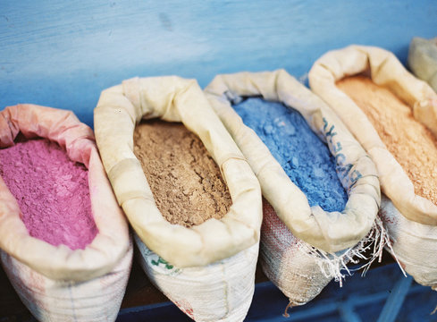Natural dyes in sacks in a row 