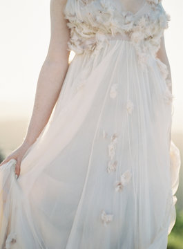 Mid section of a bride wearing wedding dress