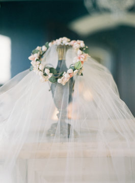 Wedding veil with flower head dress on vase