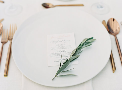 Dinner place setting with herb sprig 