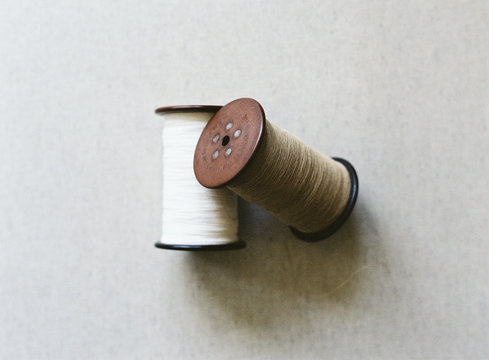 Two vintage spools with thread