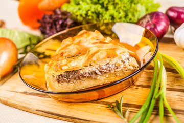 Meat pie with potato in a glass bowl
