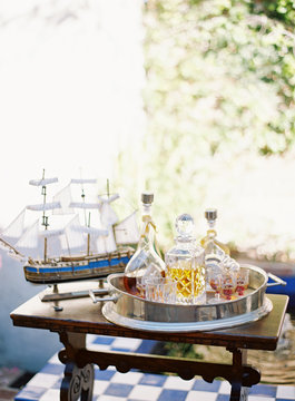 Drinks tray on table with model ship