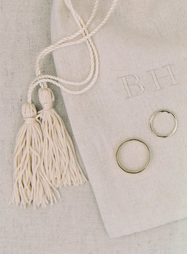 Wedding rings on fabric with tassel