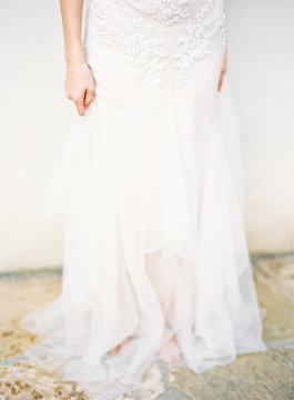 Low section of woman wearing white wedding dress