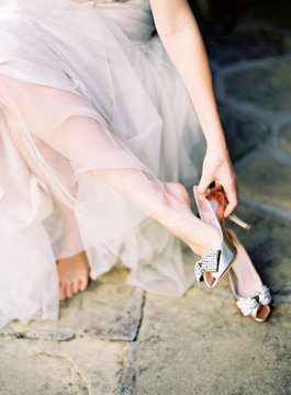 Bride putting on stiletto shoes