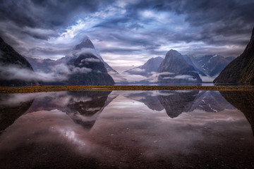 Reflection of misty mountains in lake