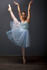 Naklejka premium young ballerina in ballet pose classical dance