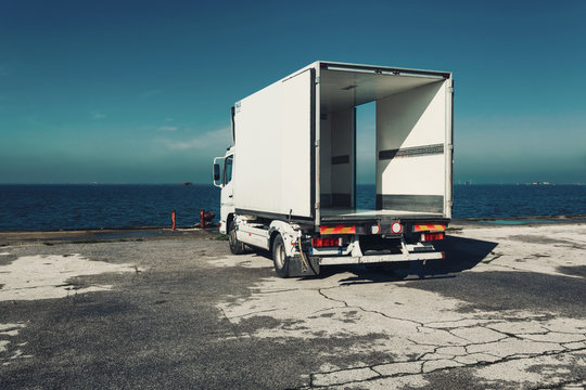 Truck parked on dick by ocean