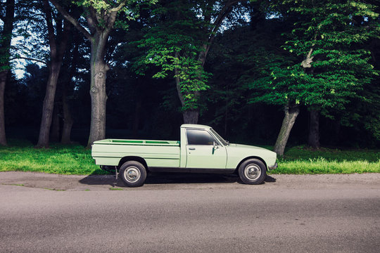 Green pick up truck parked on roadside