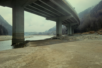 Underneath of bridge crossing river