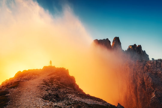 Silhouette of man standing on mountain edge