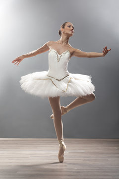 Fototapeta young ballerina in ballet pose classical dance