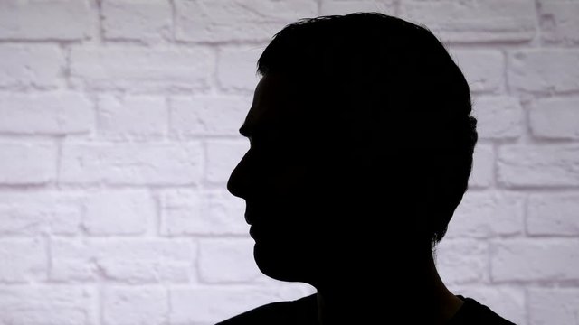 Anonymous man silhouette talking to somebody.
