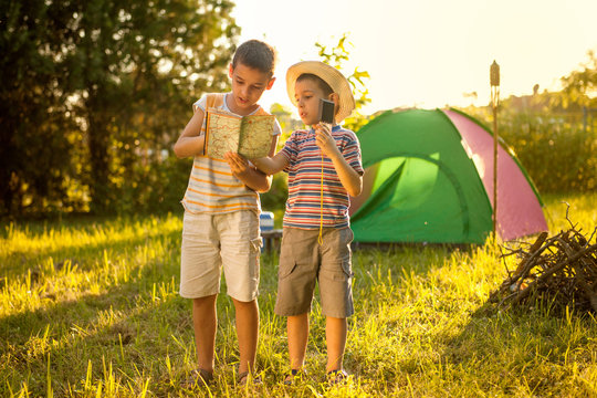 Two Boys On A Camping Trip, Learning How To Read A Compass