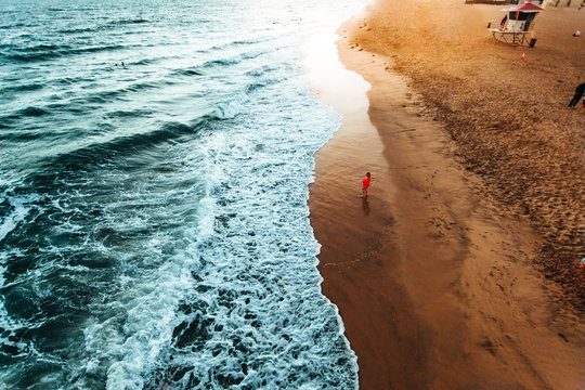 Woman on coastline by ocean 
