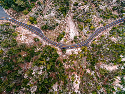 Aerial view of cars on road through mountains