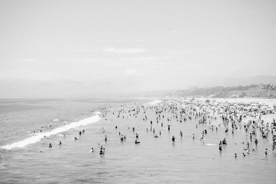 Crowd of people on beach, black and white