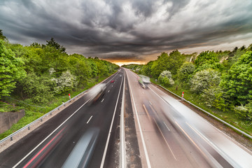 Dramatic Clouds over Busy Motorway with Vehicles in Motion