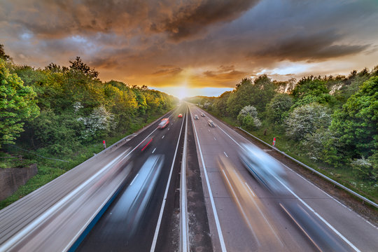 Dramatic Sunset Clouds over Busy Motorway
