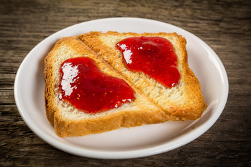 Toast with strawberry jam on a plate