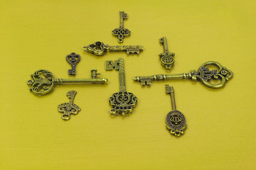Group of Brass Antique Skeleton Keys on Yellow Background