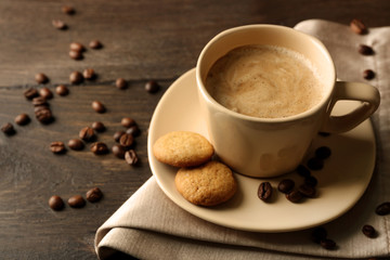 Cup of coffee on wooden table background