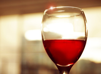 Glass of red wine on blurred background