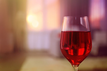 Glass of red wine on blurred background
