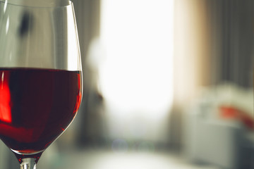 Glass of red wine on blurred background