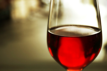 Glass of red wine on blurred background
