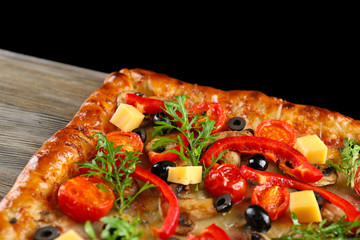 Freshly homemade pizza on black background