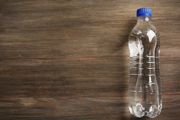 Bottled water on the wooden table, top view