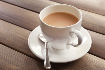 Milk tea on wooden background.