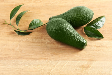Fresh avocados on wooden background