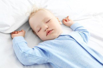 Baby sleeping on bed