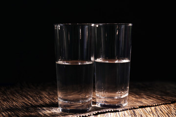 Two glasses of pure water on tablecloth