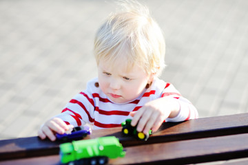 Toddler boy playing with toy cars