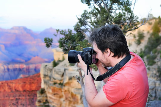 Male tourist making photo of the Grand Canyon