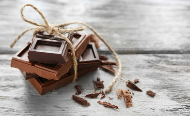 Chocolate pieces on wooden background