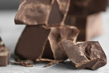 Chocolate pieces on wooden background