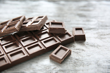 Chocolate pieces on wooden background
