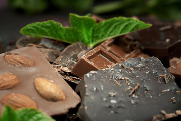 Chocolate pieces with mint leaves, background